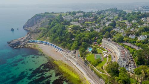 an aerial view of a town on a hill next to the ocean at The Osborne Apartments in Torquay
