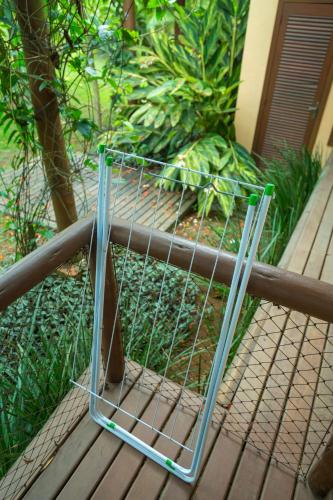 a cage sitting on a wooden deck at Paraty Villa d`agua Temporada in Paraty