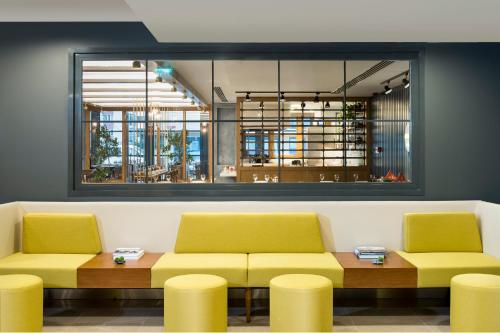 a waiting room with two yellow chairs and a table at Park Inn by Radisson Istanbul Atasehir in Istanbul