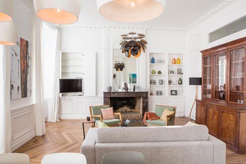 - un salon avec un canapé, des chaises et une cheminée dans l'établissement Intendance beautiful apartment, à Bordeaux