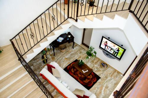 an overhead view of a living room with a couch and a television at South Olives in Żejtun