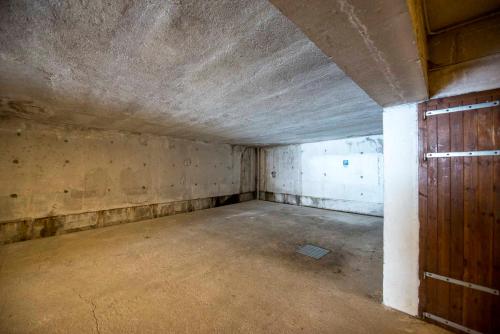 an empty room in an old building with a door at Casa Penia 2 in Canazei