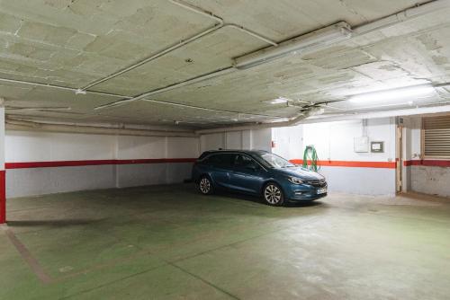 a car that is parked in a garage at AT apartamentos & VTV Conde de Torrejón 10 in Seville