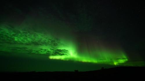 an image of the northern lights in the sky at Arctic Aurora Borealis cottages in Nuorgam