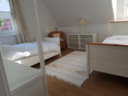 a bedroom with two beds and a desk and a mirror at Apartment am Park in Lehrte