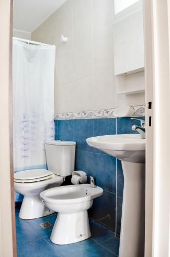 a bathroom with two toilets and a sink at Lofty Departamentos Temporarios in Cordoba