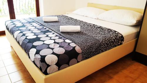 a bed with two pillows on it in a room at Sea Panorama Villa in Mimice