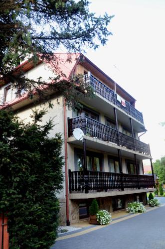 a large building with balconies on the side of it at Willa Gościnny Próg in Krościenko
