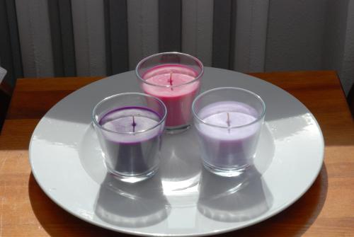 three candles on a white plate on a table at Willa Gościnny Próg in Krościenko