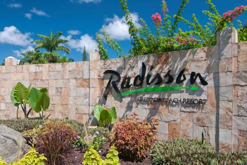 a sign for the rucchini garden at the resort at Radisson Grenada Beach Resort in Grand Anse