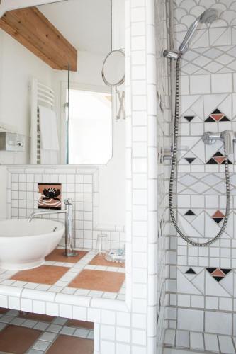 a bathroom with a shower and a sink at Insel-Hof Reichenau Hotel-garni in Reichenau