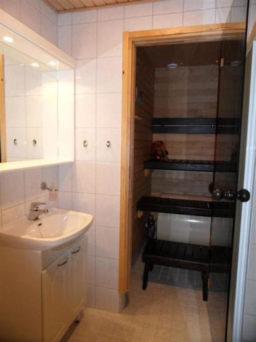 a small bathroom with a sink and a shower at Aparthotel YlläStar in Äkäslompolo