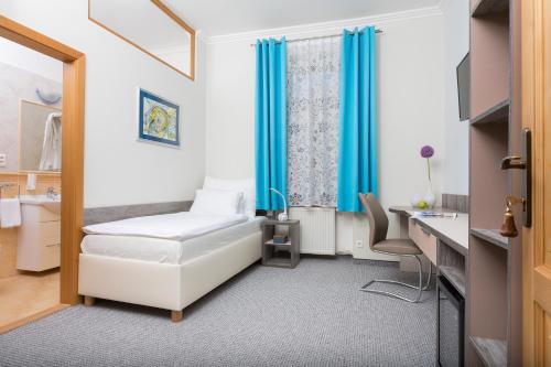 a hospital room with a bed and a desk at Penzión Hradbová Old Town Residence & SPA in Košice