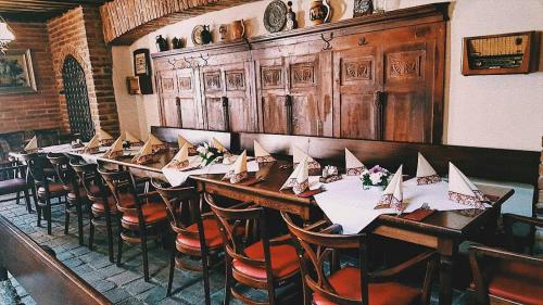 a long table in a restaurant with paper boats on it at Hotel Sokolský Dům in Domažlice
