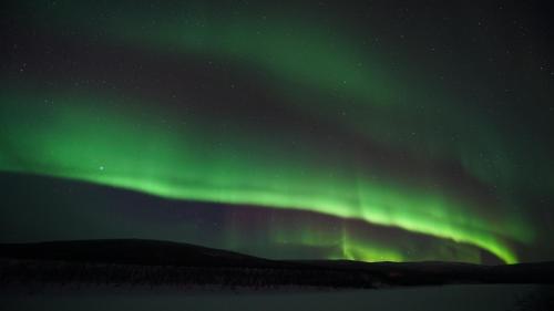 an image of the northern lights in the sky at Osman Kelohovi in Utsjoki