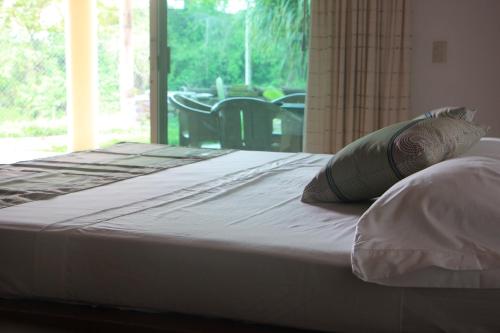 a bed with two pillows sitting on top of it at Casa Del Sol in Lo de Marcos