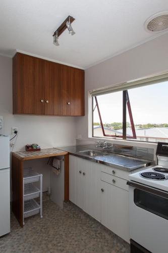 a kitchen with a sink and a window at Alton Lodge Motel in Whakatane