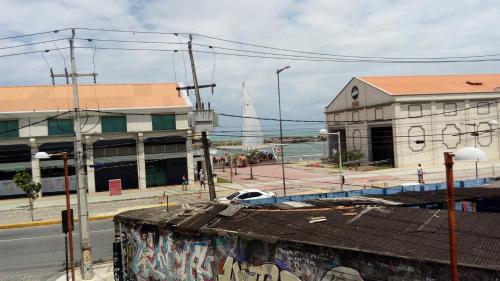 a building with graffiti on the side of a street at Mangue Oranje Hostel - no bairro do Recife Antigo - Old Town in Recife