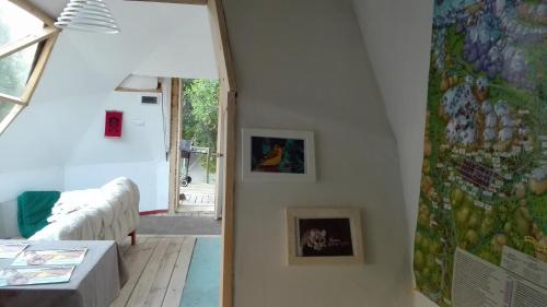 a room with a wall with pictures on the wall at Cabaña El Ingenio in El Ingenio