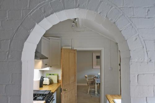 an archway in a kitchen with a table at 30 Overleigh Road in Chester