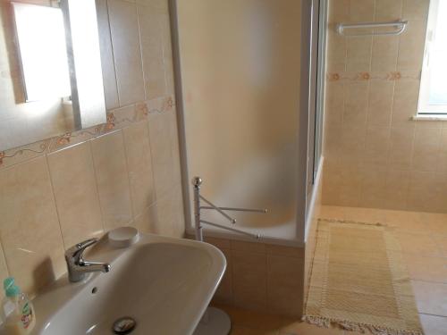 a bathroom with a toilet and a sink and a shower at Casa Nova da Barreira in Cavaleiro