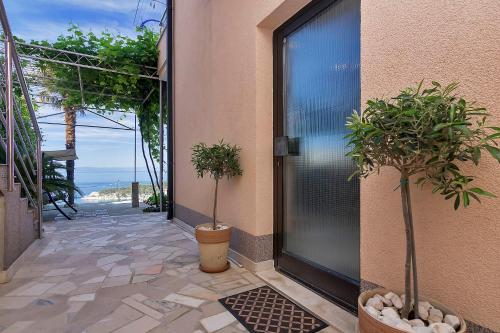 a room with a door with a view of the ocean at Villa Sukara in Makarska