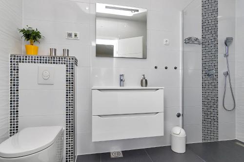 a bathroom with a toilet and a sink and a shower at Villa Sukara in Makarska