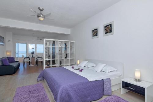 a bedroom with a large bed and a living room at Villa Sukara in Makarska