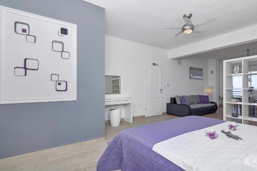 a white bedroom with a bed and a couch at Villa Sukara in Makarska