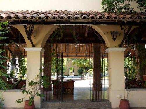 an entry to a building with an iron gate at Hotel Quinta Minera in Cosalá