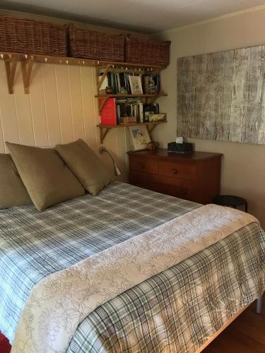 a bedroom with a bed and a dresser at Merrynook in Pinehurst
