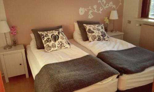 a bedroom with two beds with pillows on them at BSG Apartments in Selfoss