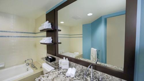 a bathroom with a sink and a large mirror at Aava Whistler Hotel in Whistler