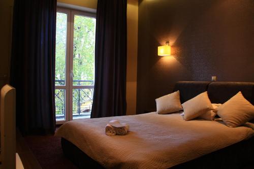 a bedroom with a large bed with a window at Apart Rooms Marszalkowska by WarsawResidence Group in Warsaw
