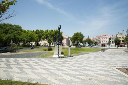a cobblestone street in a city with buildings at Hotel Solaris in Setúbal