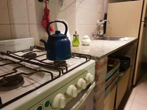 a tea kettle sitting on top of a stove in a kitchen at Casa Mandarina in La Punta