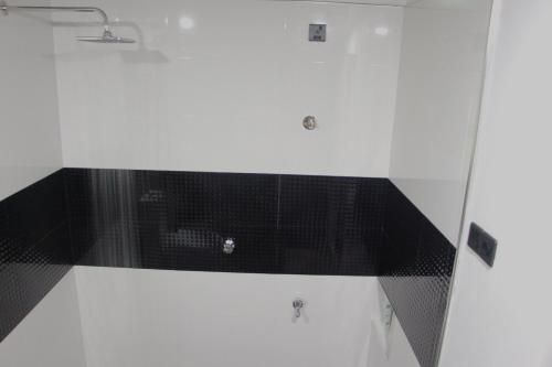 a bathroom with a black and white tile floor at Jegers Villa in Negombo