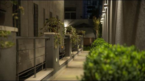 a balcony with potted plants on the side of a building at Shams Alweibdeh Hotel Apartments in Amman