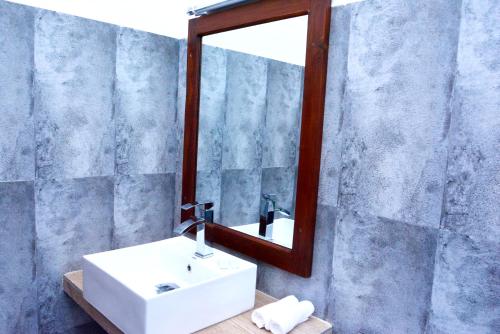 a bathroom with a sink and a mirror at Paradise Forest Garden in Matale