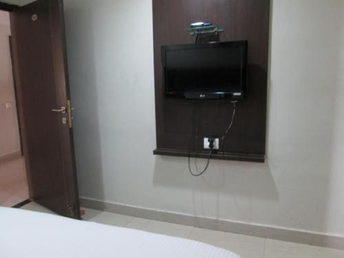 a television on a wall in a room at Hotel Imperial Classic in Hyderabad