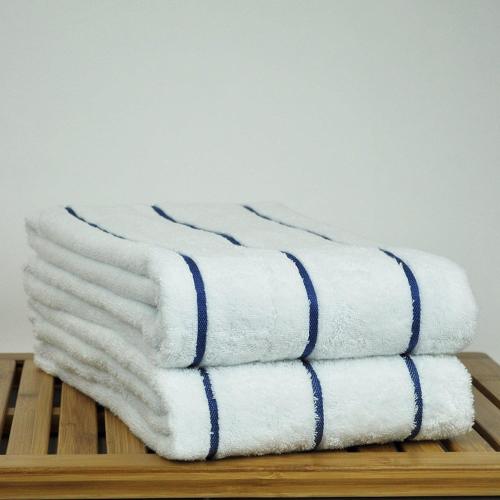 a stack of towels sitting on a wooden rack at Kenz Residency in Cochin