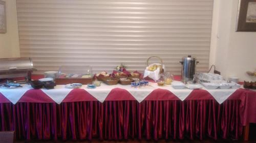 a table with a red and white table cloth at Nasz Klub - Pokoje Gościnne in Poznań