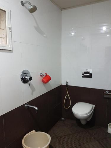 a bathroom with a toilet and a sink at Jojies Homestay Fortkochi in Cochin