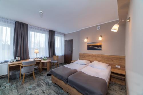 Ένα ή περισσότερα κρεβάτια σε δωμάτιο στο Hotel Pod Jesiotrem