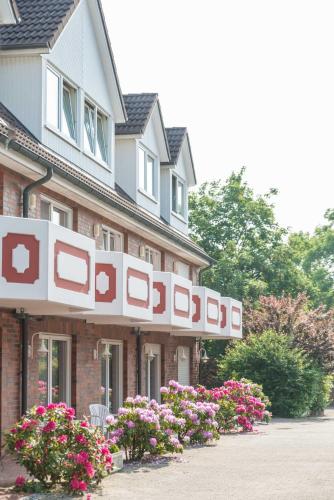 a building with a sign on the side of it at Landhaus Braband in Cuxhaven