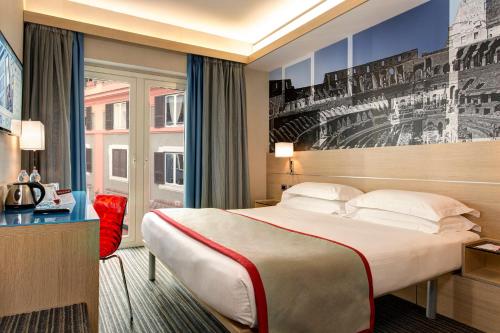 a hotel room with a bed, desk and a painting on the wall at iQ Hotel Roma in Rome