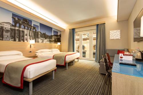 Postel nebo postele na pokoji v ubytování iQ Hotel Roma