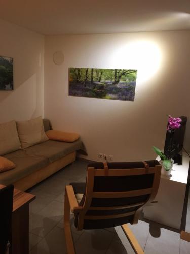 a living room with a couch and a chair at Haus Melodie in Wiler
