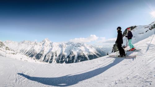 a group of people standing on a snow covered mountain at Haus Melodie in Wiler