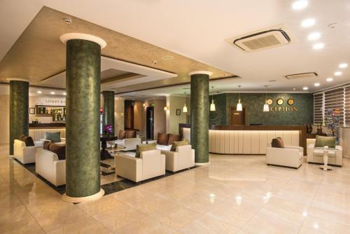 a lobby of a hotel with chairs and a bar at Hotel Miramar Sozopol in Sozopol